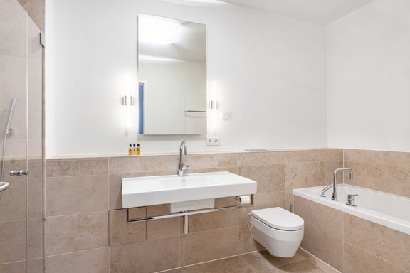 Modern bathroom with bright fine stone tiles