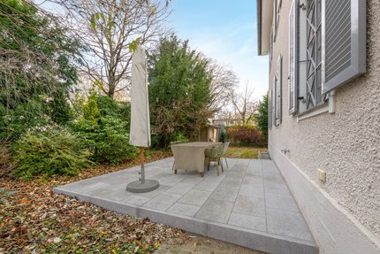 The natural stone terrace offers an additional seating area