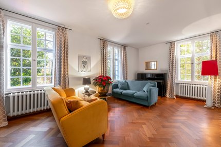 Cozy living area with large lattice windows