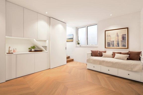 Bright hobby, guest and utility area in the basement