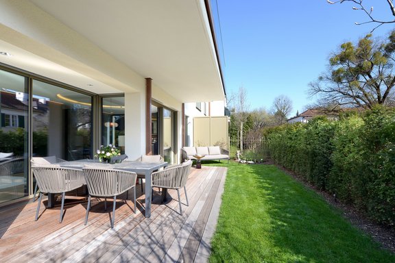 A terrace with adjoining lawn forms a sunny outdoor retreat for many months of the year