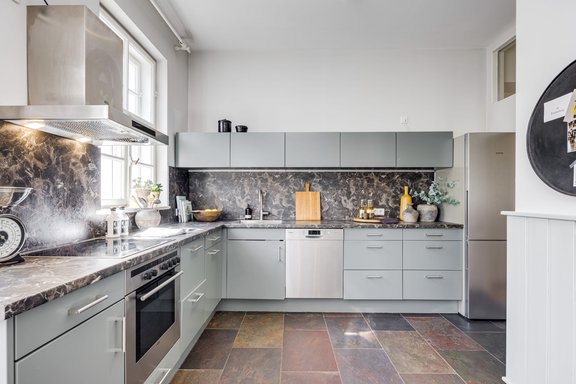 Kitchen-living room with natural stone floor and fixtures