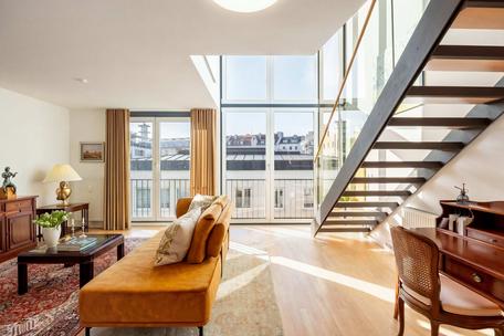 Abundant light above the city skyline: a loft-style duplex with a rooftop terrace
