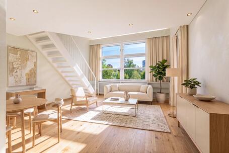 Exclusive attic apartment with a loft: Spacious living area and south-facing windows—needs renovation