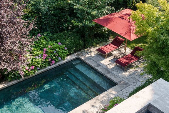 Relaxing by the natural stone pool