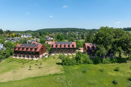 New Construction: Mid-house with a private sun deck in an idyllic location and lake views